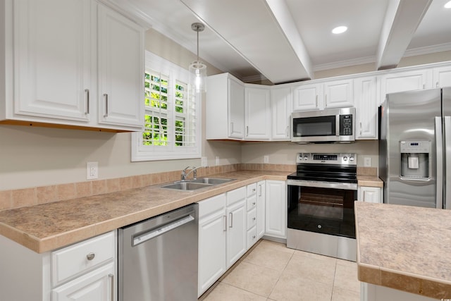 kitchen with beam ceiling, hanging light fixtures, appliances with stainless steel finishes, white cabinetry, and sink