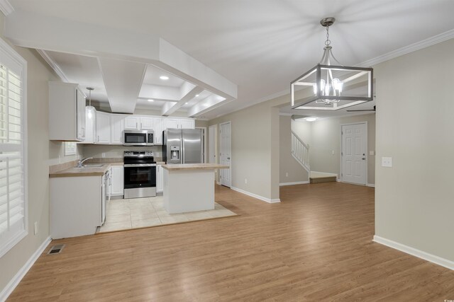 3758 Loblolly Ave, Little River, SC 29566 - kitchen with visible vents, a center island, a sink, light wood-style flooring, and appliances with stainless steel finishes