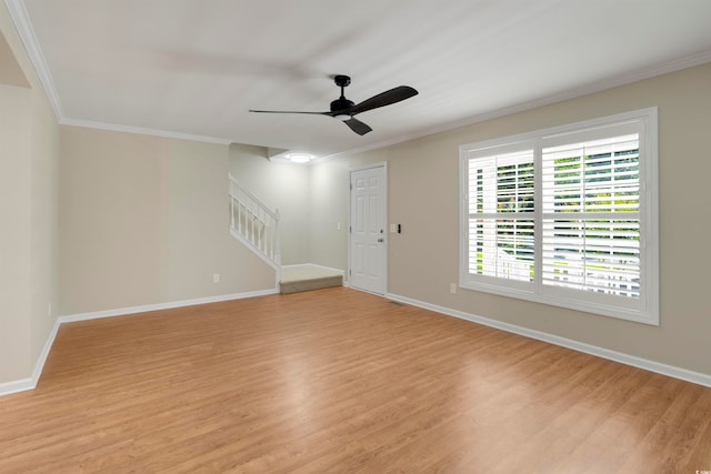 empty room featuring ceiling fan, crown molding, and light hardwood / wood-style flooring