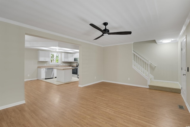 3758 Loblolly Ave, Little River, SC 29566 - unfurnished living room featuring crown molding, ceiling fan, light wood finished floors, and stairs