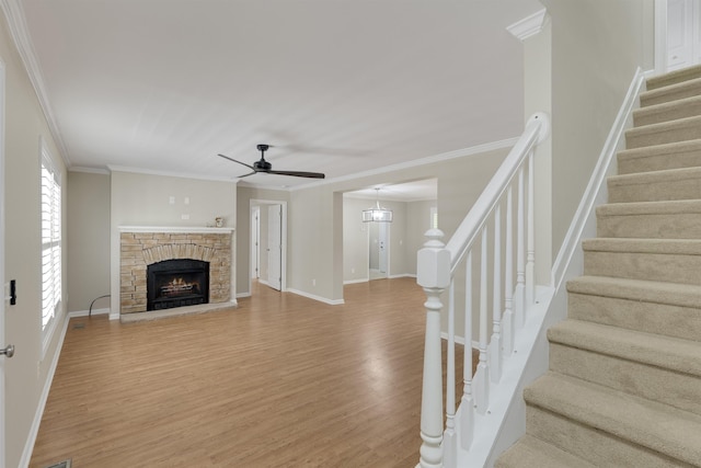 3758 Loblolly Ave, Little River, SC 29566 - unfurnished living room with ceiling fan, a fireplace, stairway, ornamental molding, and light wood-style flooring