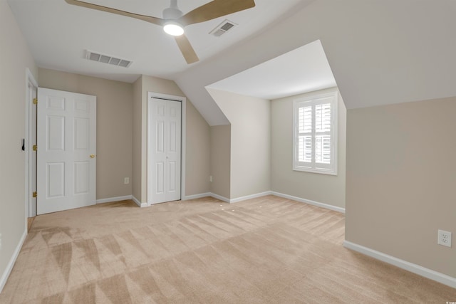 bonus room with ceiling fan, light colored carpet, and vaulted ceiling