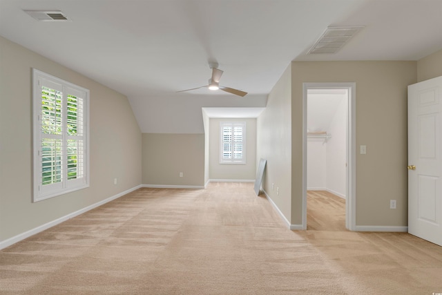 bonus room with light carpet, lofted ceiling, and ceiling fan