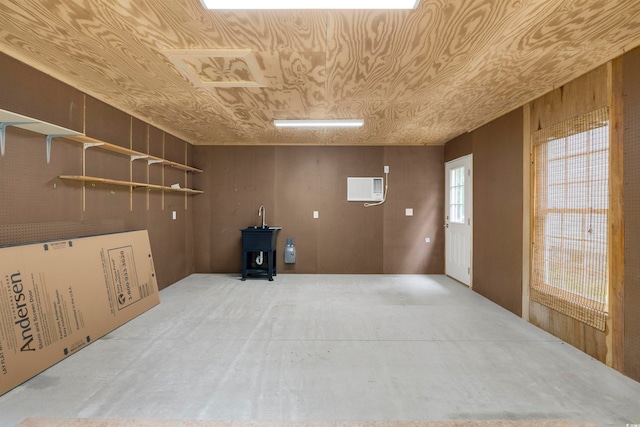 spare room featuring an AC wall unit and wooden walls