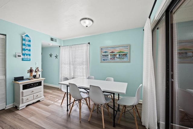 dining area with light hardwood / wood-style floors