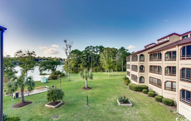 view of home's community featuring a yard and a water view