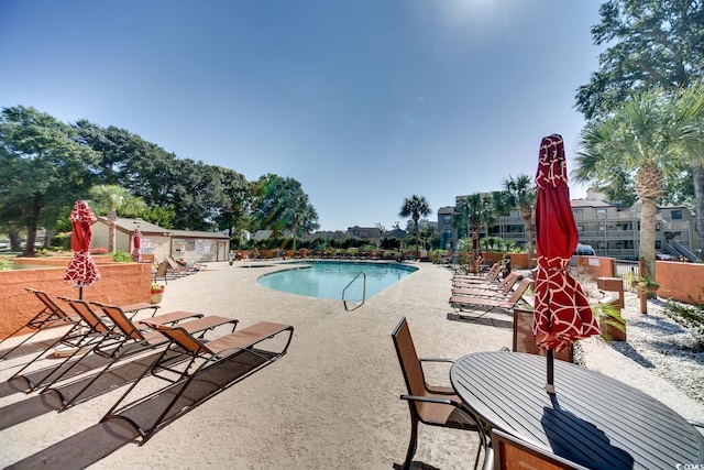 view of swimming pool featuring a patio area