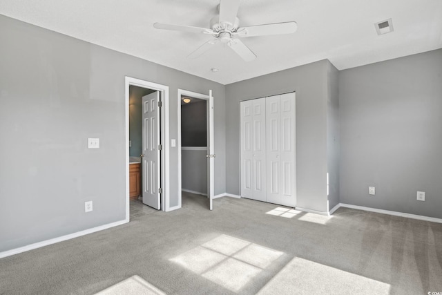 unfurnished bedroom featuring ceiling fan, light colored carpet, and a closet