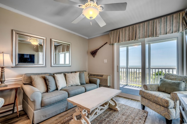 living room with crown molding, a wall mounted AC, ceiling fan, and light hardwood / wood-style flooring