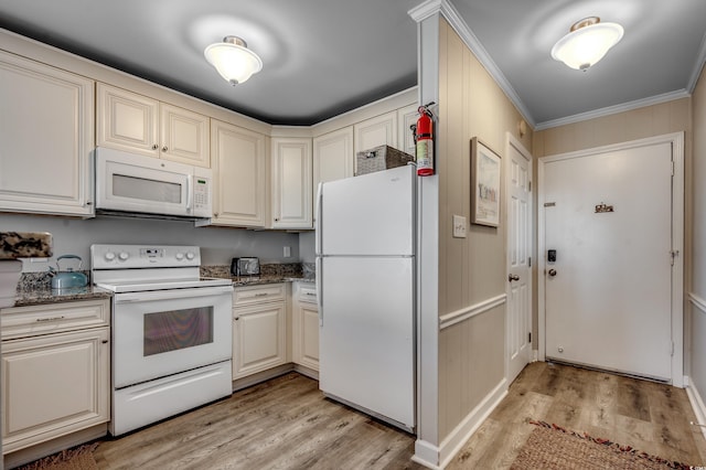 kitchen featuring light wood-type flooring, white appliances, cream cabinetry, dark stone counters, and crown molding