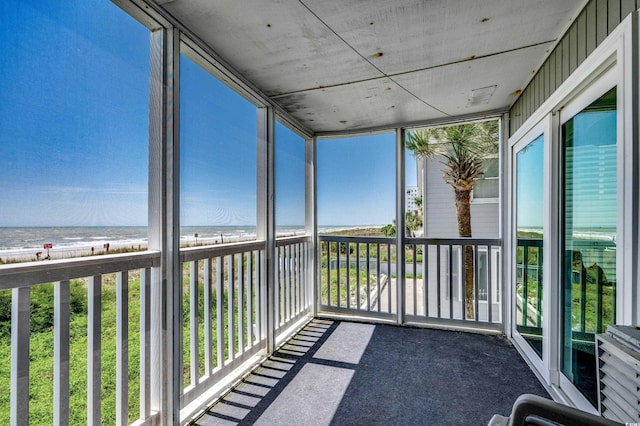 unfurnished sunroom with a water view