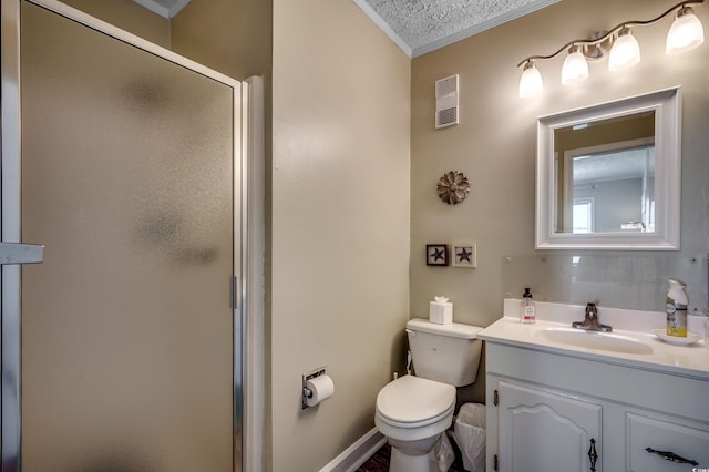 bathroom with vanity, ornamental molding, a textured ceiling, toilet, and a shower with door