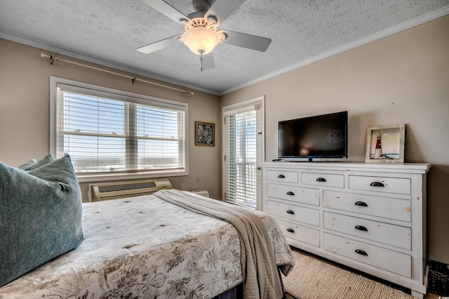 bedroom with a textured ceiling, crown molding, and ceiling fan