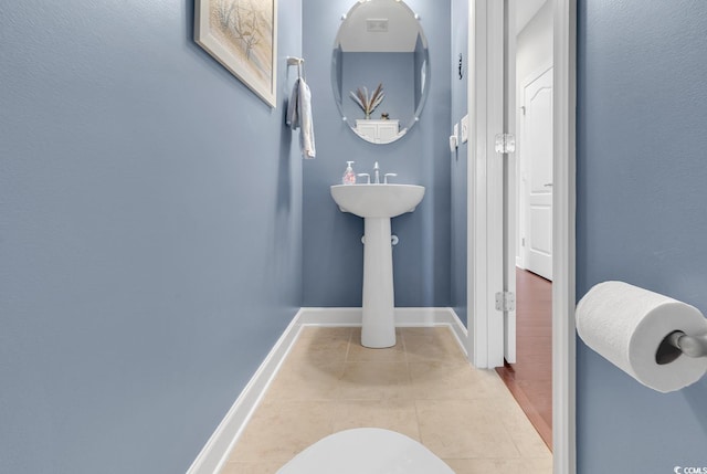 bathroom featuring toilet and tile patterned flooring