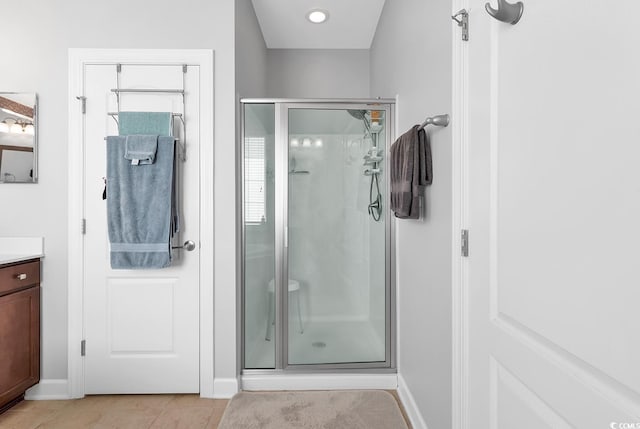 bathroom featuring vanity, tile patterned floors, and a shower with shower door