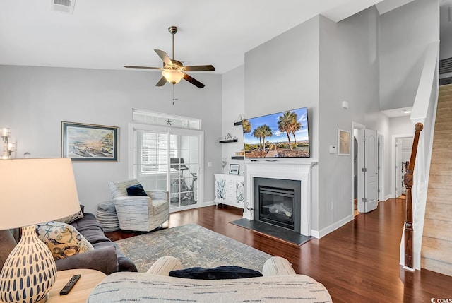 living room with ceiling fan, high vaulted ceiling, and dark hardwood / wood-style flooring