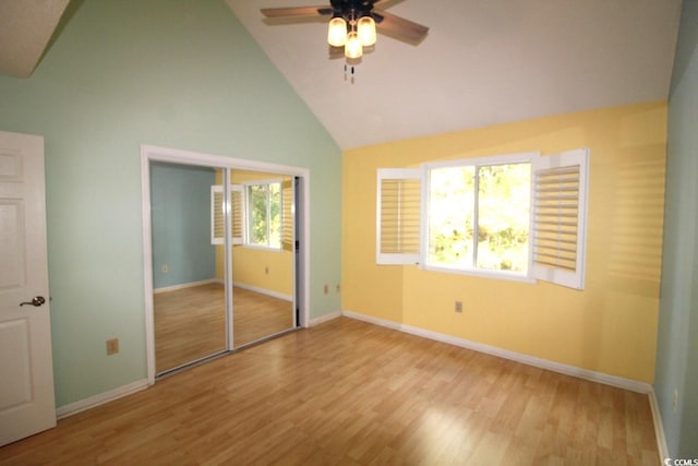 unfurnished bedroom featuring light hardwood / wood-style flooring, multiple windows, ceiling fan, and a closet