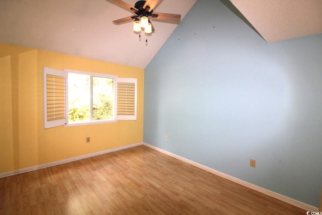 spare room featuring hardwood / wood-style floors, ceiling fan, and vaulted ceiling