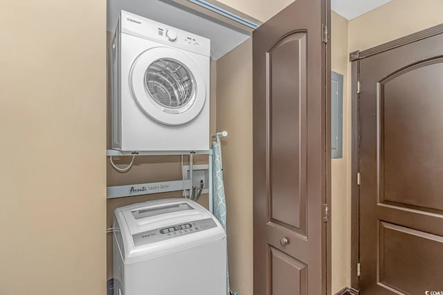 clothes washing area with stacked washer / dryer