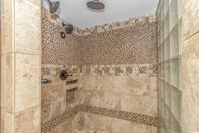 interior details featuring a tile shower