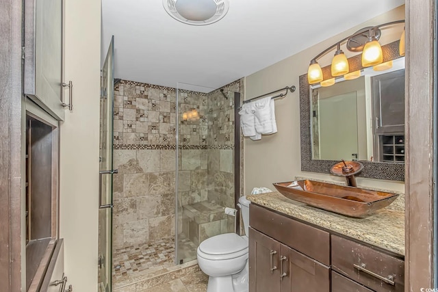 bathroom with vanity, toilet, and an enclosed shower