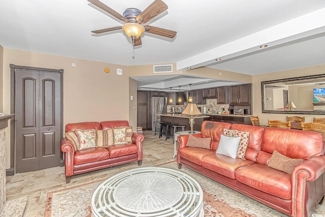 living room with ceiling fan and sink