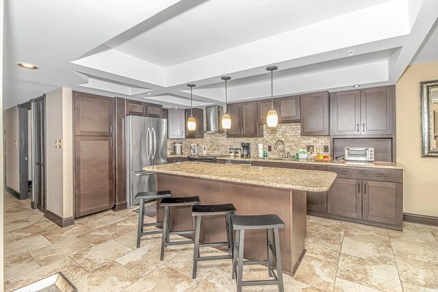 201 74th Ave N Unit 1002, Myrtle Beach, SC 29572 - kitchen featuring freestanding refrigerator, wall chimney exhaust hood, a raised ceiling, a sink, and baseboards