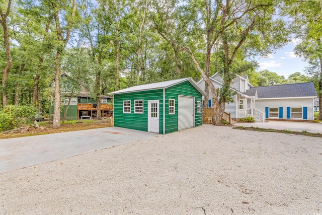 view of front of house featuring a deck and a storage shed