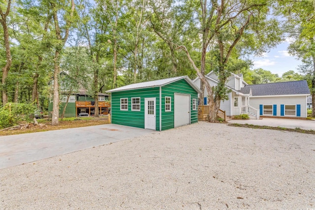 exterior space with an outbuilding and concrete driveway