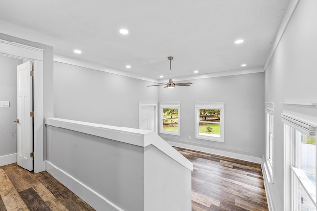 hallway with crown molding, an upstairs landing, baseboards, recessed lighting, and dark wood-style flooring
