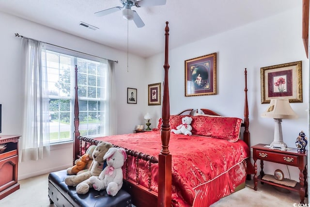 bedroom featuring multiple windows, ceiling fan, and light colored carpet