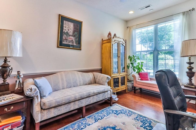 living room with dark hardwood / wood-style flooring and a textured ceiling