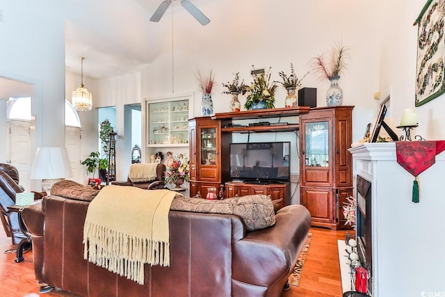 3412 Westminster Dr, Myrtle Beach, SC 29588 - living area featuring a fireplace with flush hearth, ceiling fan, and light wood-type flooring
