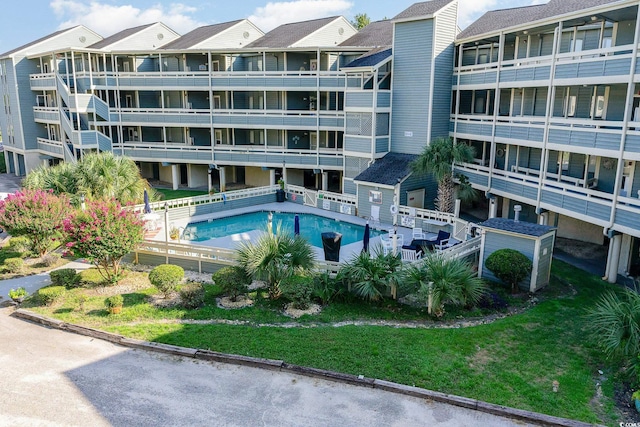 view of pool with a lawn