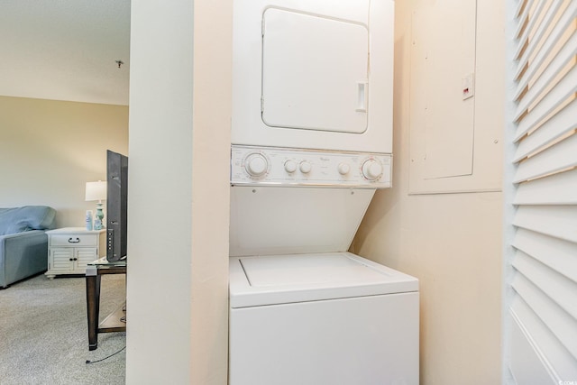 washroom with light carpet and stacked washer / drying machine