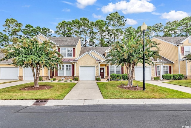 view of front of home with a front yard and a garage