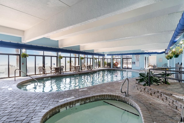 view of pool featuring a patio area and an indoor hot tub