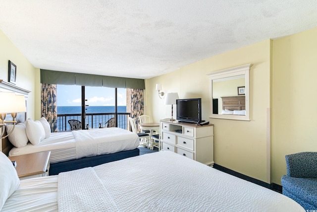 bedroom with carpet, access to exterior, and a textured ceiling