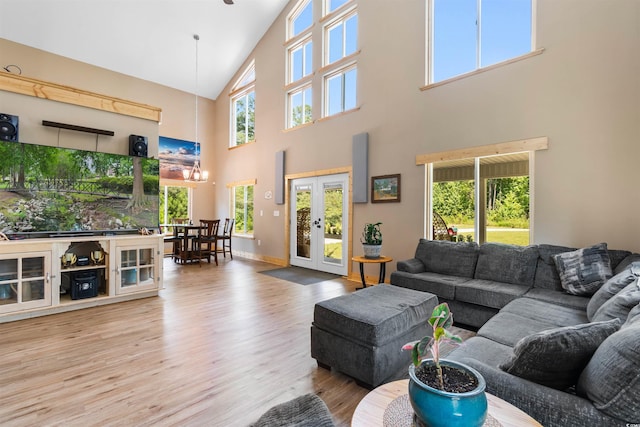 living room featuring baseboards, wood finished floors, and french doors