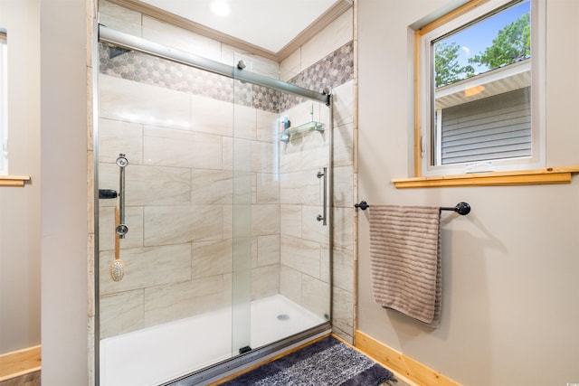 bathroom featuring a stall shower and baseboards