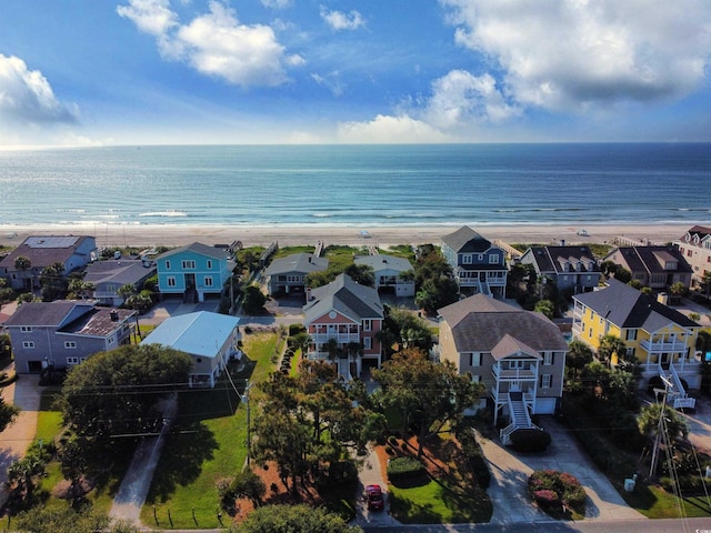 drone / aerial view featuring a view of the beach and a water view