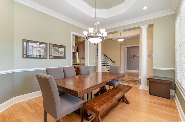 dining space with a wealth of natural light, light hardwood / wood-style floors, and crown molding