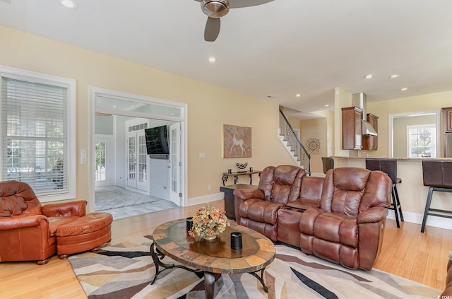 living room featuring light wood-type flooring and ceiling fan