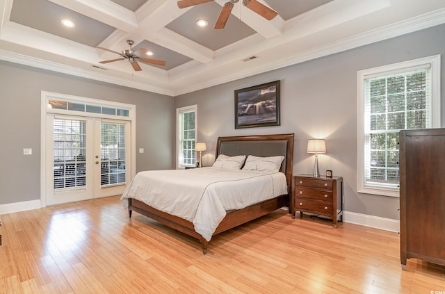 bedroom featuring light hardwood / wood-style flooring, multiple windows, and crown molding