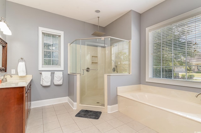 bathroom with vanity, tile patterned flooring, and plus walk in shower