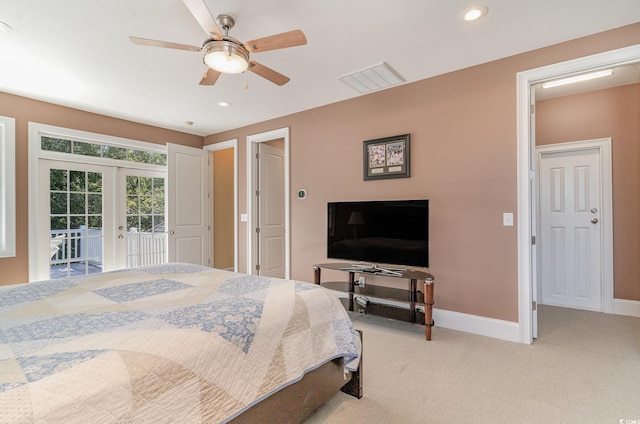 bedroom featuring access to exterior, french doors, light carpet, and ceiling fan