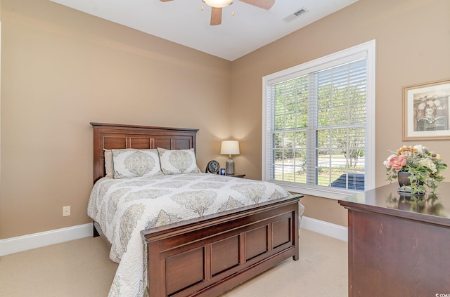 carpeted bedroom featuring ceiling fan and multiple windows