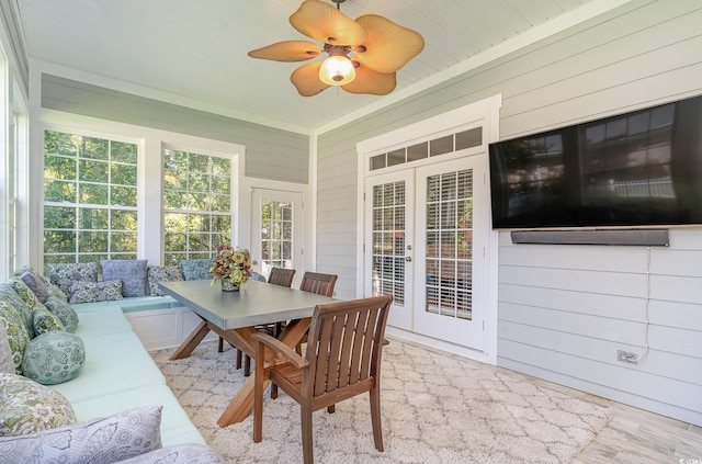 sunroom / solarium featuring french doors and ceiling fan