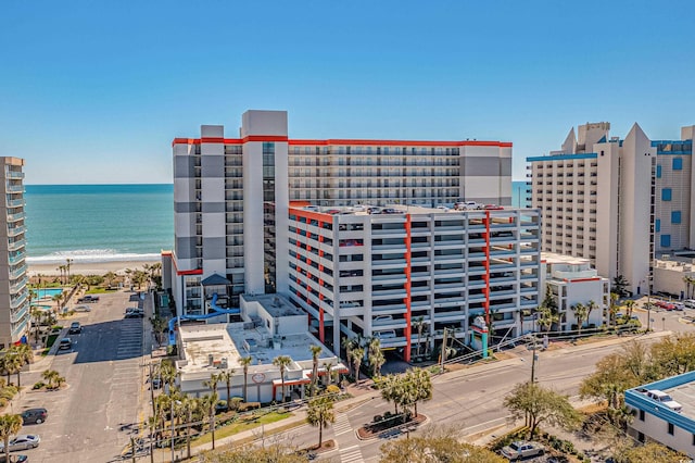 view of building exterior with a view of the beach and a water view