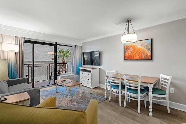 dining space with hardwood / wood-style floors and crown molding